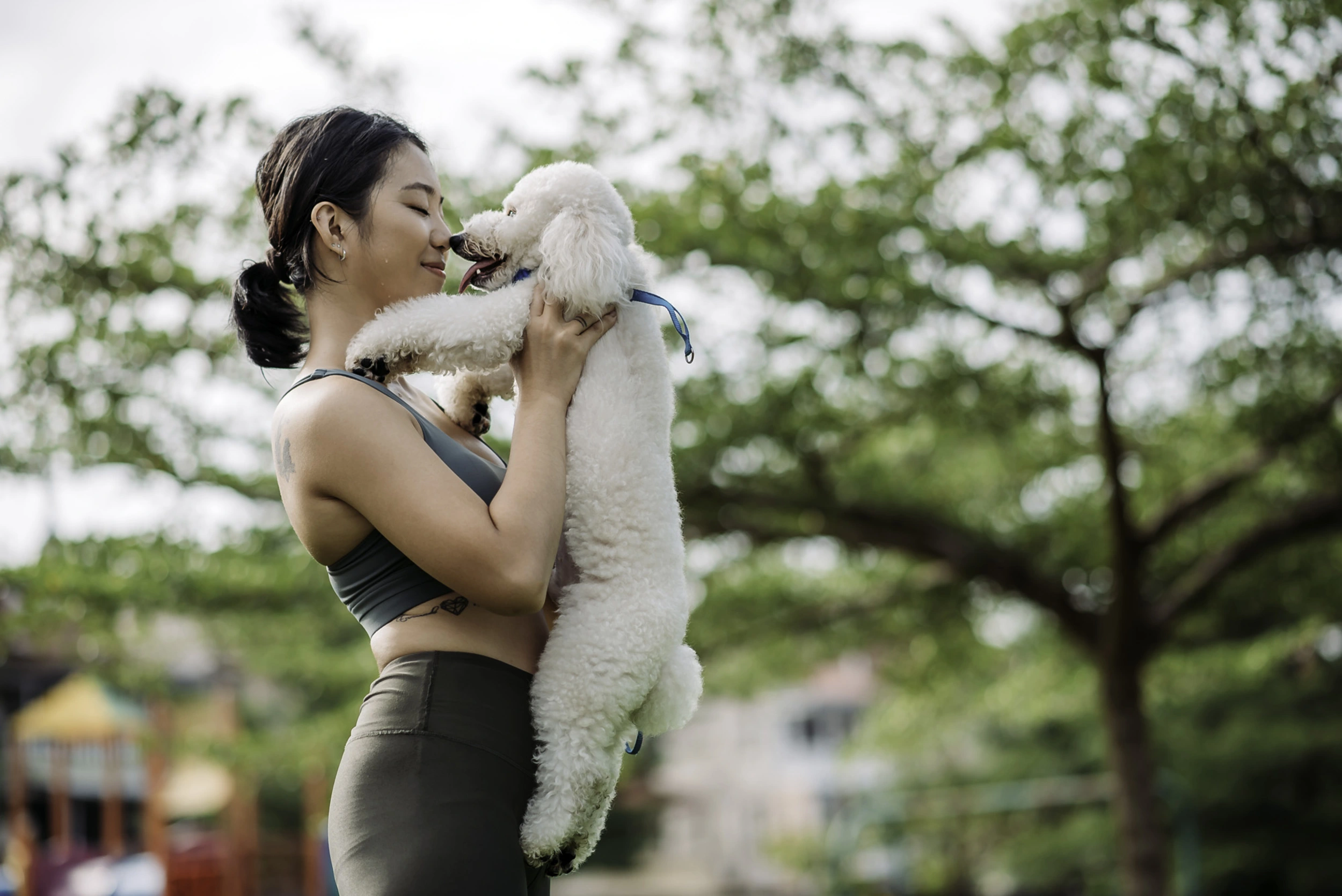 woman holding dog at pet friendly the henry apartments charlotte